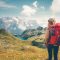 Woman with backpack enjoying mountains landscape view hiking