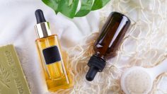 Cosmetic bottle with serum and hyaluronic acid , palm leaf, olive soap and Reusable shopping bags on a white towel