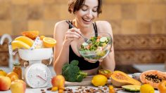 Sports woman with healthy food on the kitchen
